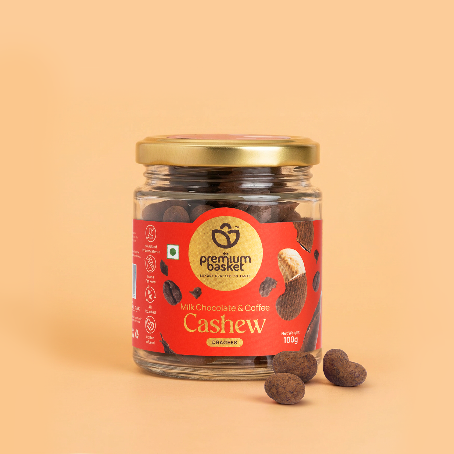 Milk chocolate coffee cashew jar with gold lid and cashews on surface