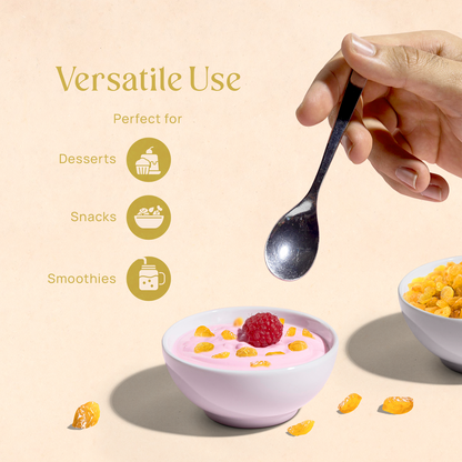 Bowl of golden raisins with spoon and scattered raisins around