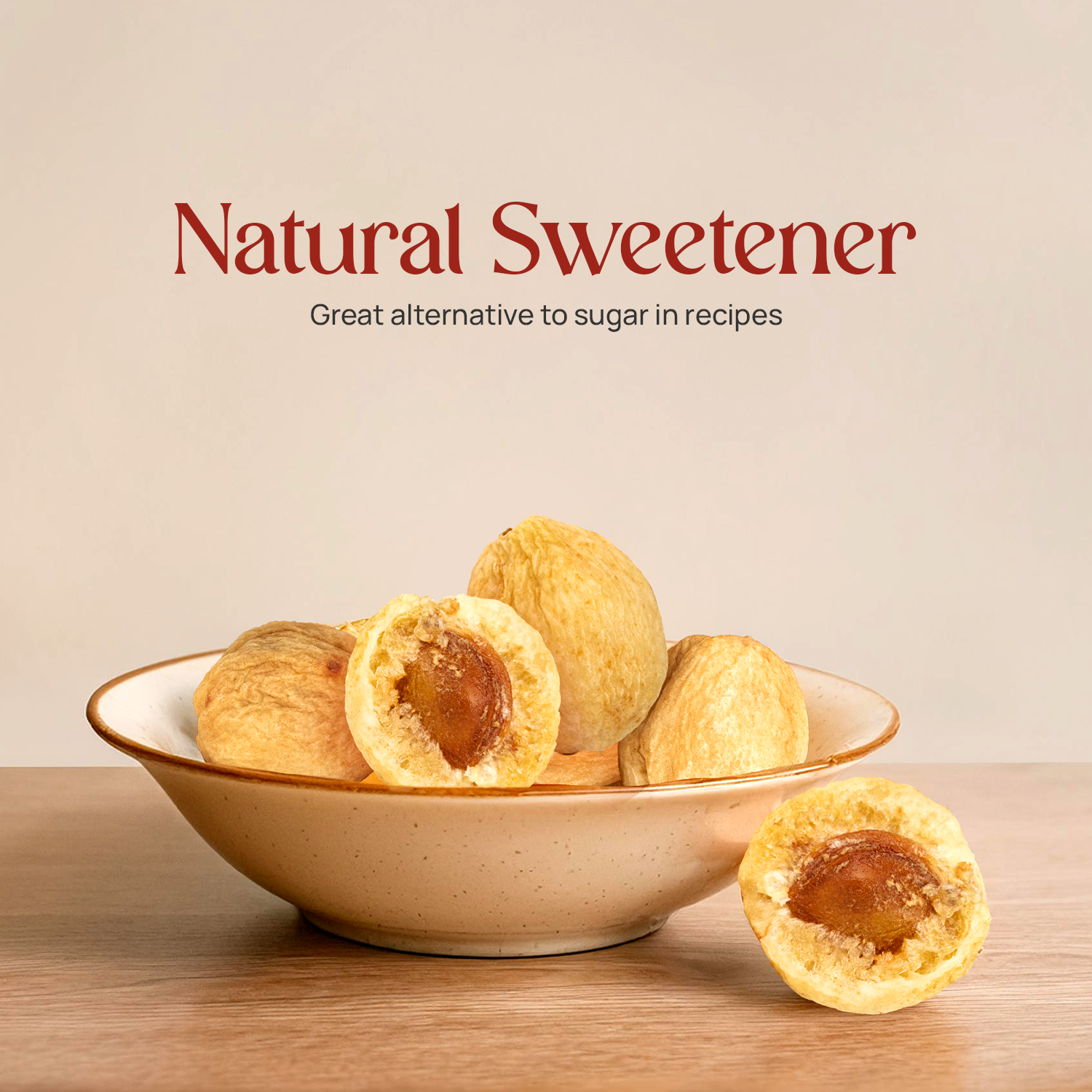 Dried apricots in a speckled bowl, with one cut half and whole pieces