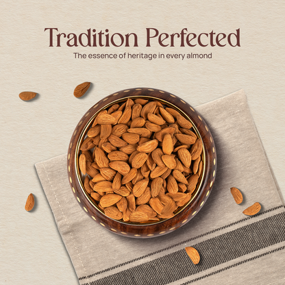 Bowl of golden-brown almonds with scattered kernels on cloth