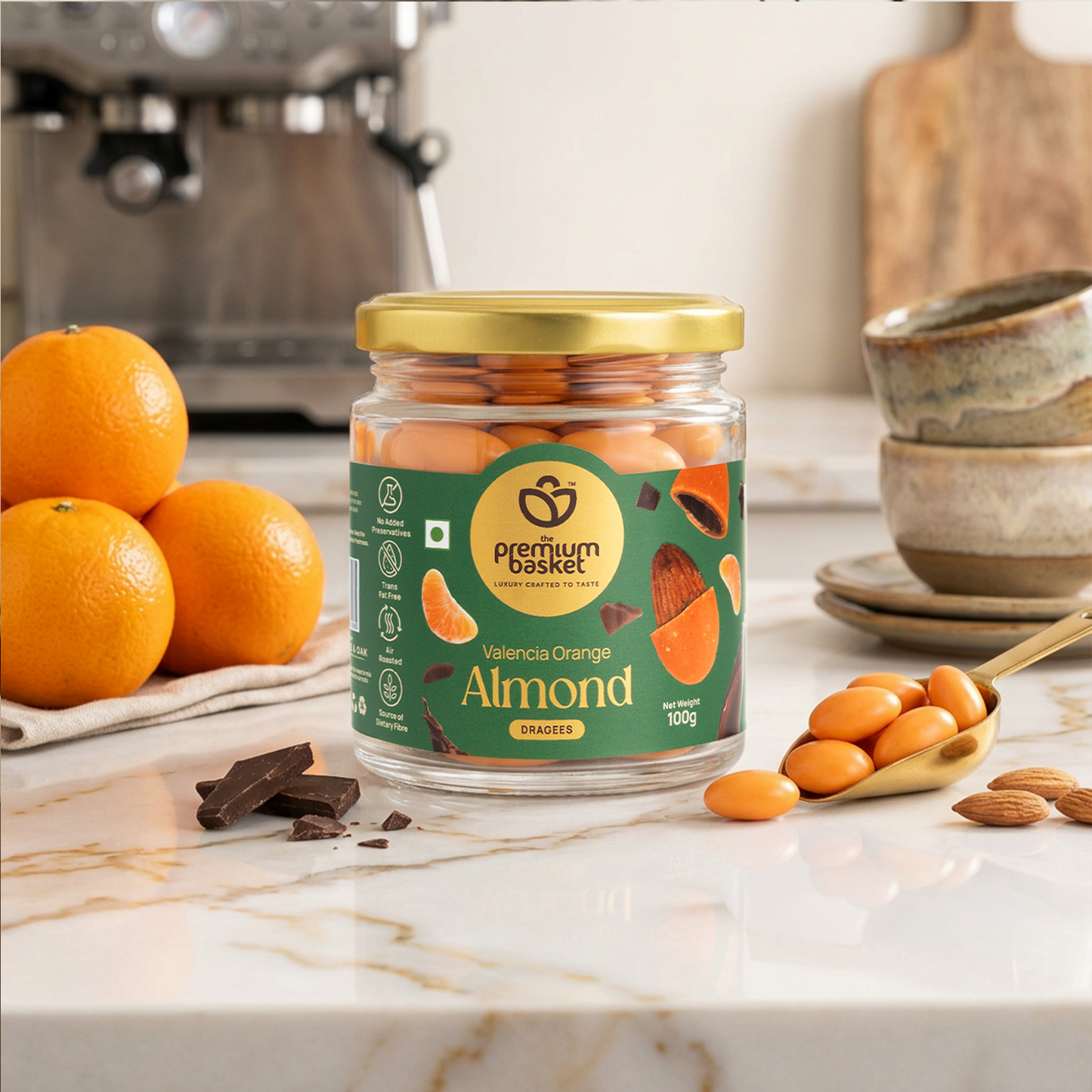 Valencia Orange Almond jar with gold lid and orange almonds on marble surface