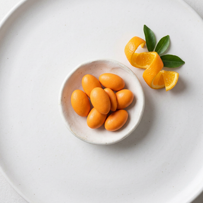 Valencia Orange Almonds in a bowl with orange slices and peeled almonds