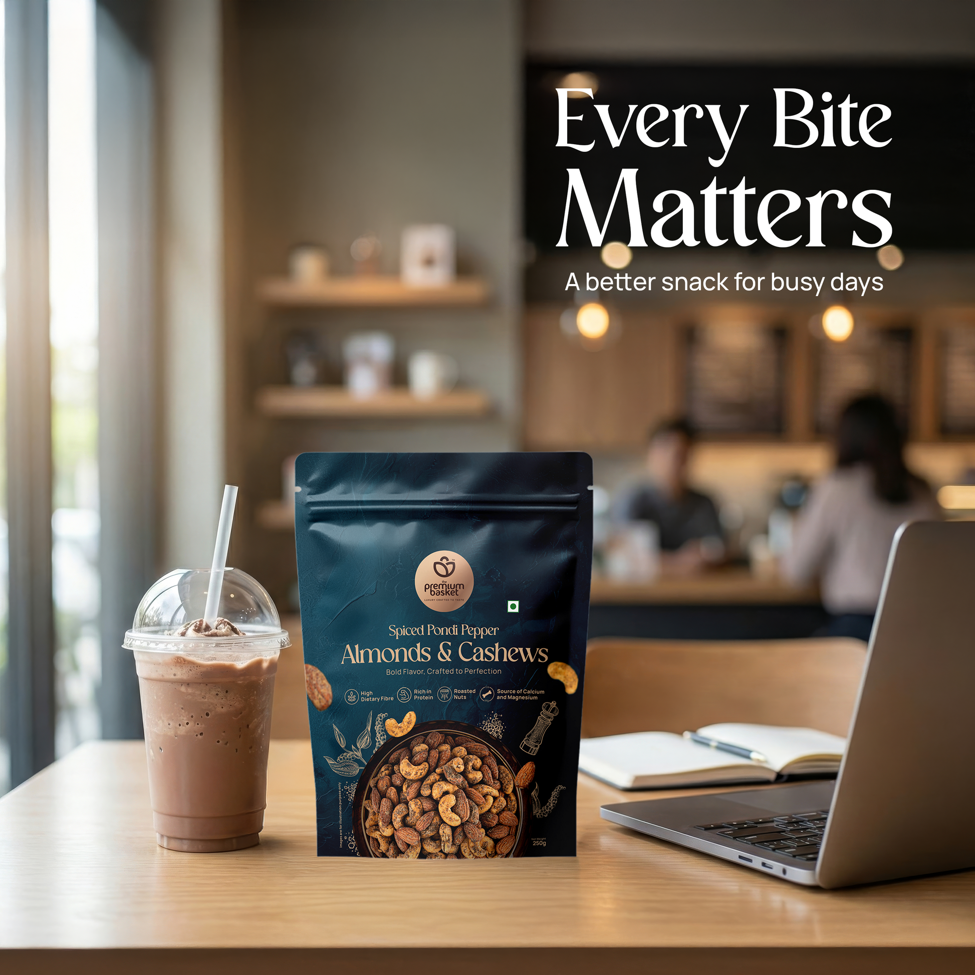 Spiced Pondi Pepper Almonds & Cashews snack bag on desk with iced drink nearby