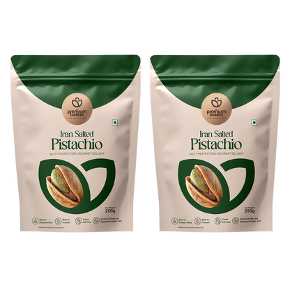 Two salted pistachio pouches standing side by side, green top and white front