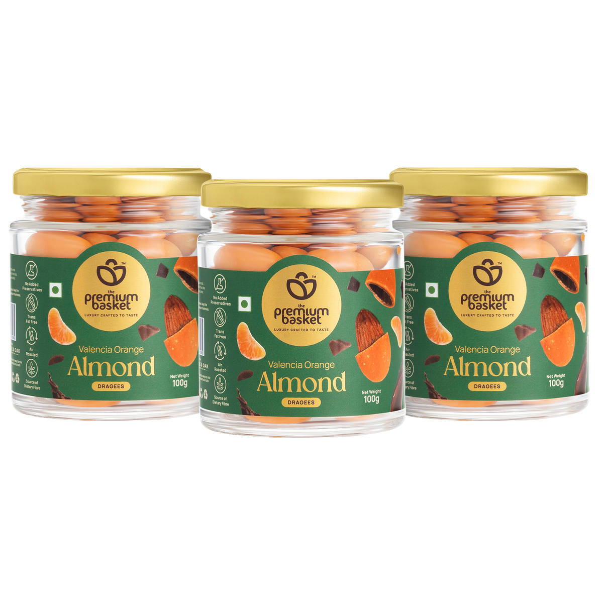 Three glass jars of orange-flavored almond snacks, gold lids, green labels